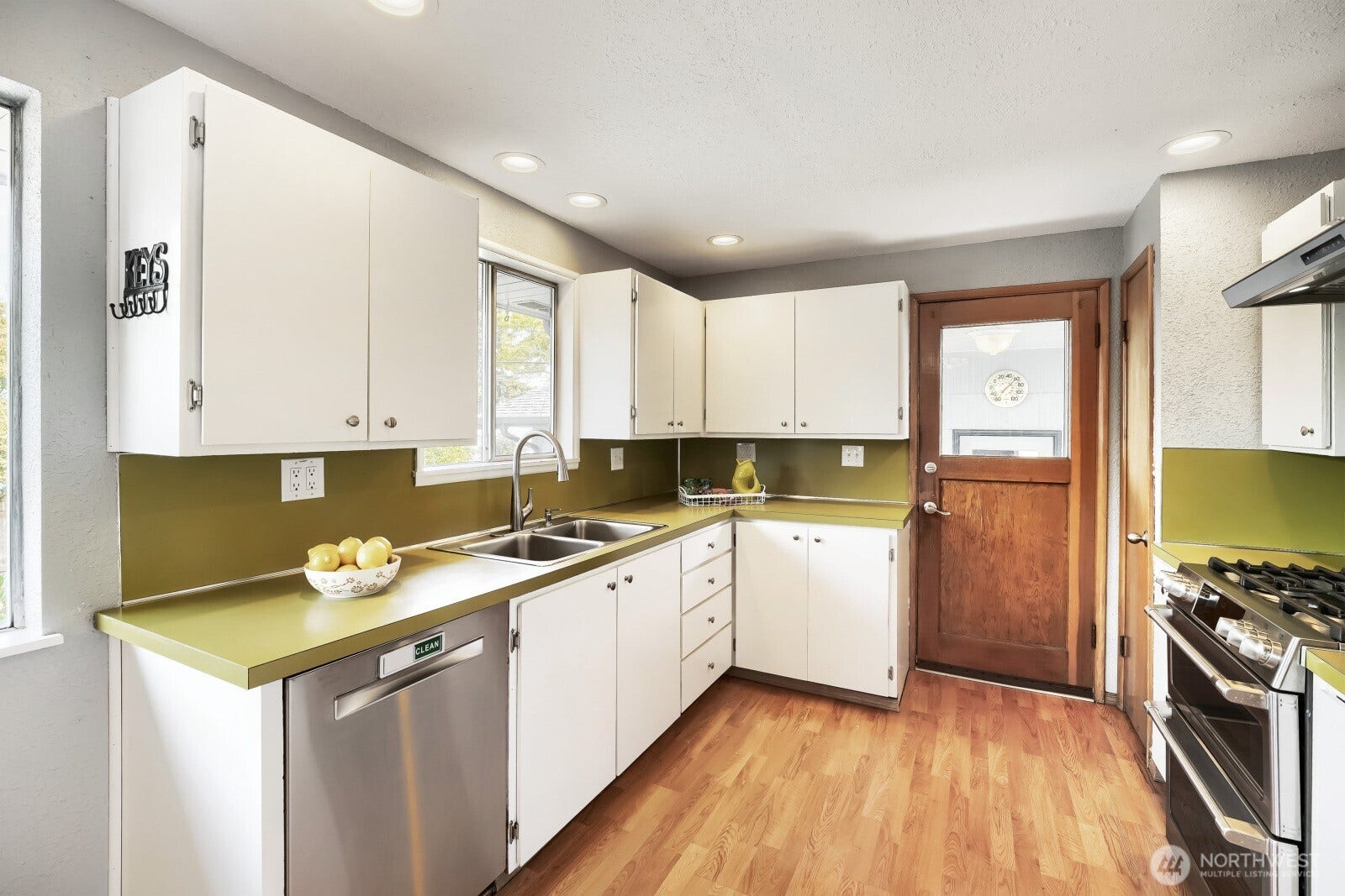 5013 N 33 Street, Tacoma, WA 98407 Main floor kitchen features updated appliances - the gas stove also retains an electrical hookup option for future owners flexibility.