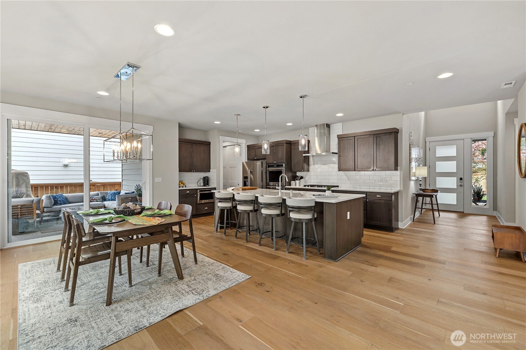 Dining and kitchen with a view of the front entry