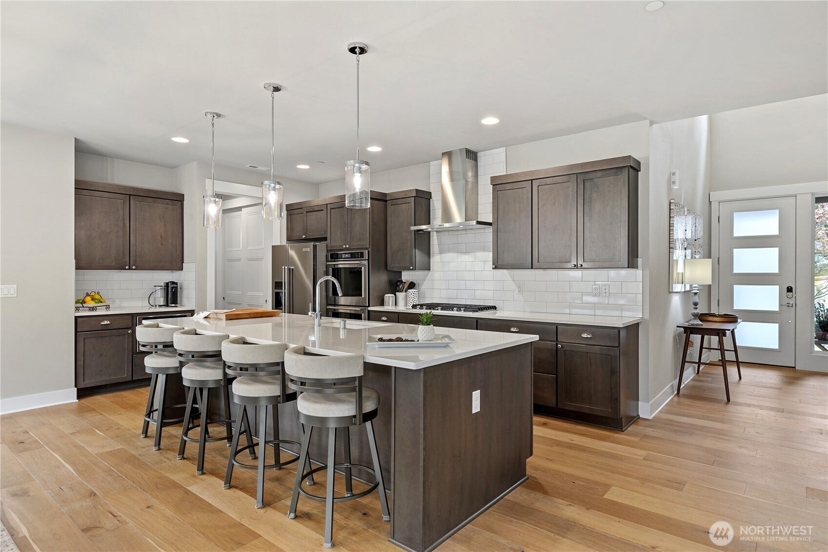 Kitchen features a large island and a coffee counter.