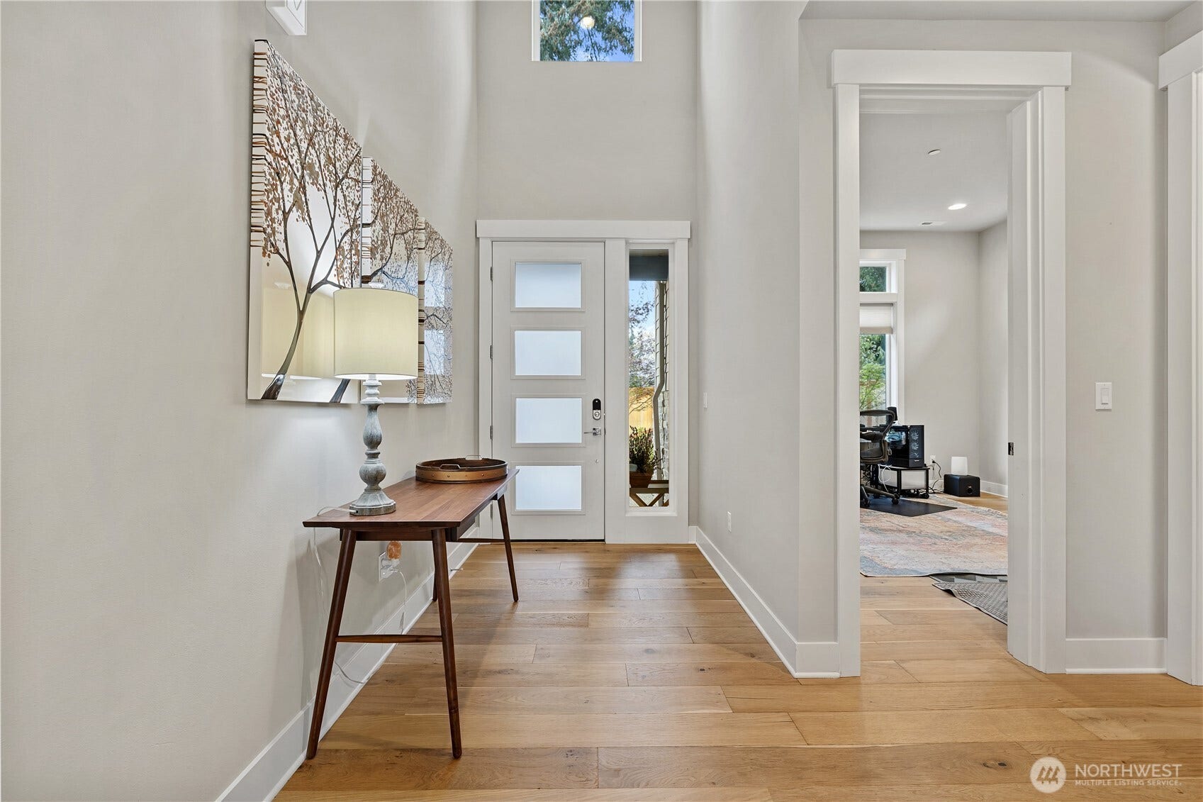 View of the entry area, front door and office