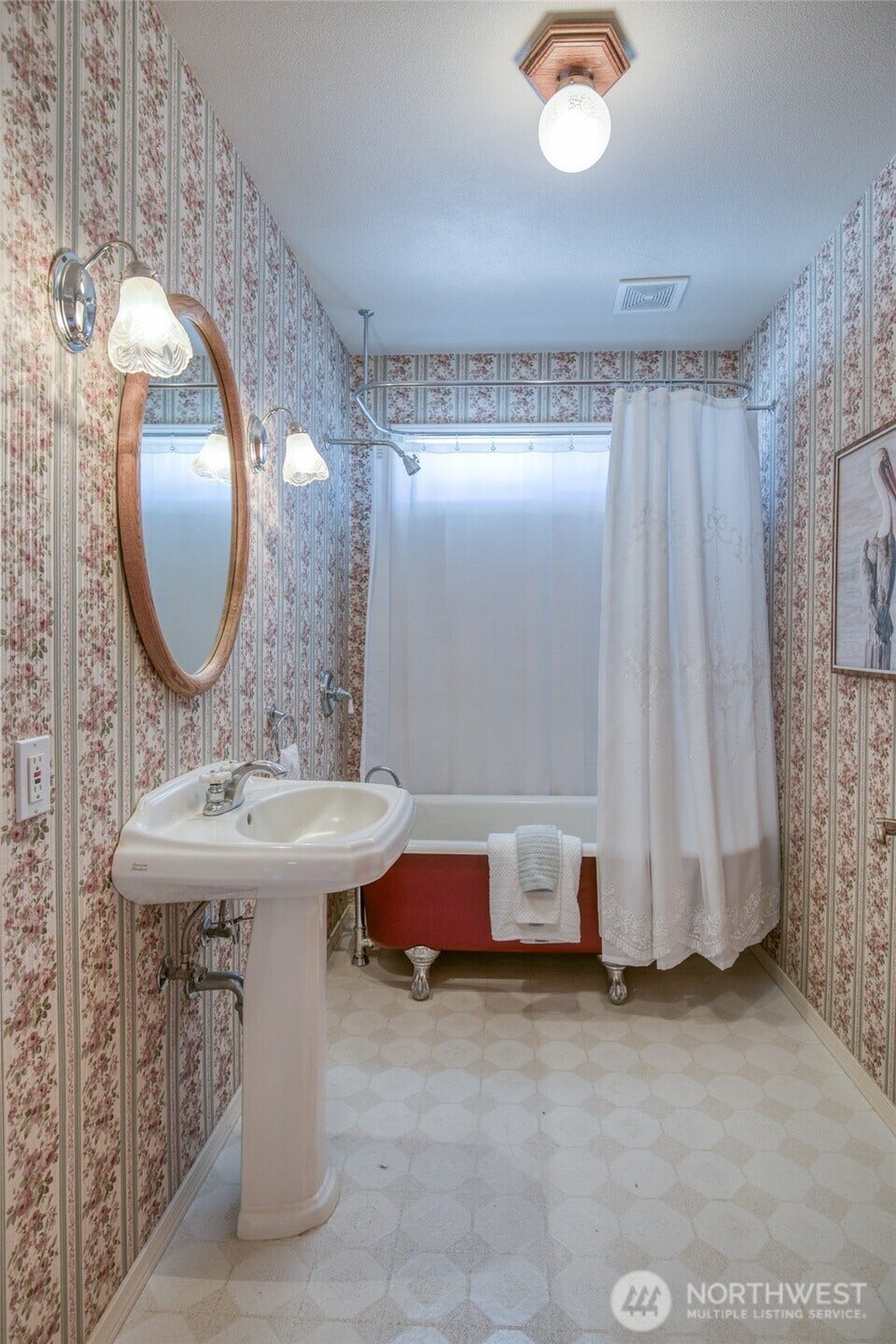 Guest bathroom with vintage clawfoot tub and pedestal sink
