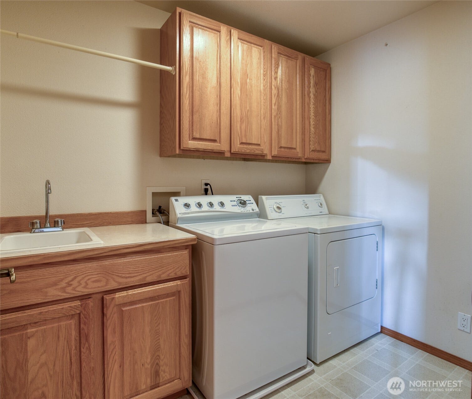 Laundry room with soaking sink and storage