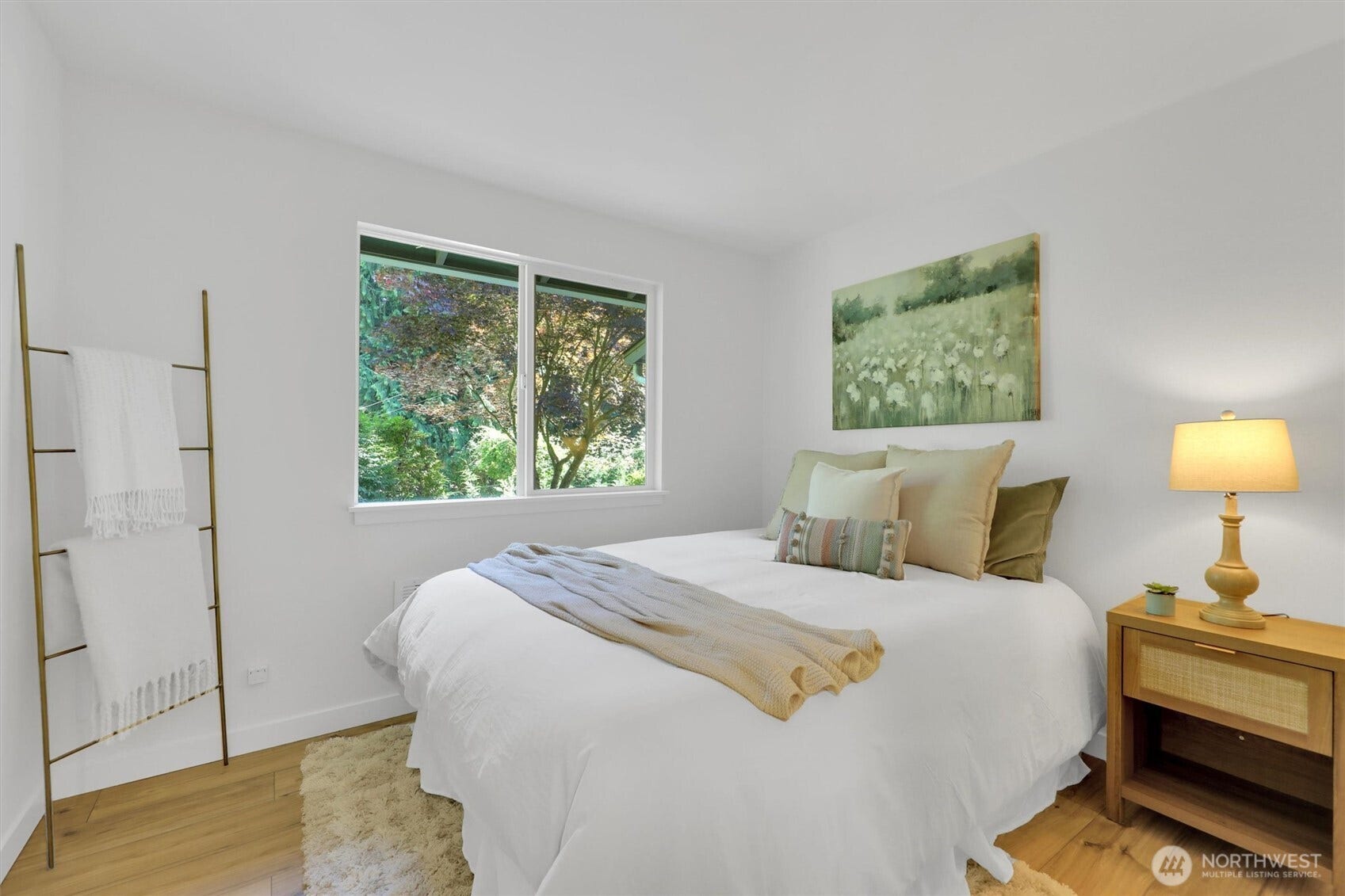 20915 W Richmond Road, Bothell, WA 98021 Bright bedroom featuring a comfortable bed, hardwood floors, bedside table, large window, and neutral dcor.