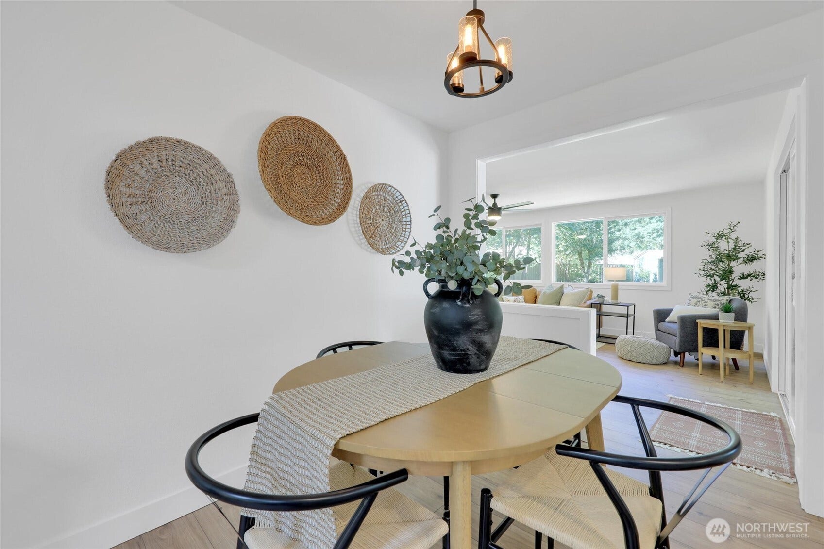 20915 W Richmond Road, Bothell, WA 98021 Inviting dining area with a round table, contemporary chairs, pendant lighting, decorative wall accents, and a large window.