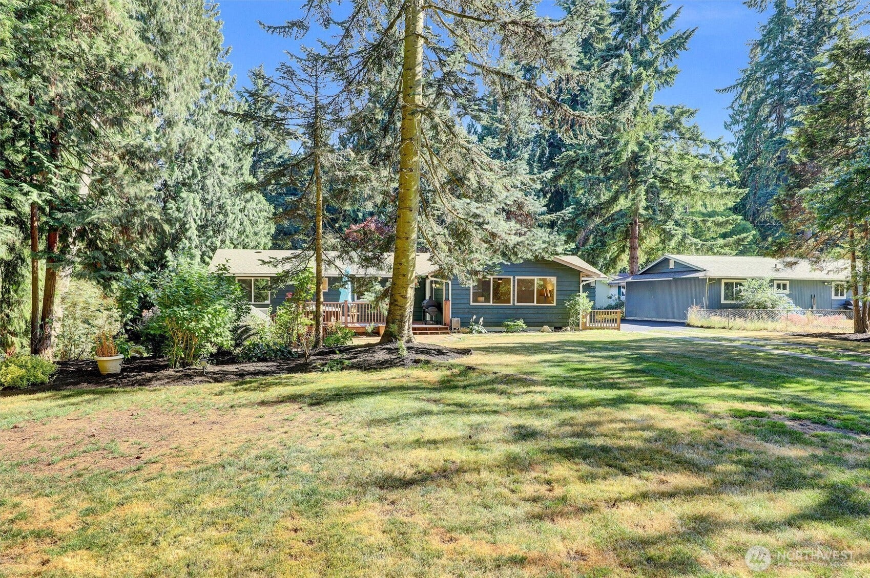 20915 W Richmond Road, Bothell, WA 98021 Expansive front yard and exterior view of the Bothell property surrounded by mature evergreen trees and established landscaping.