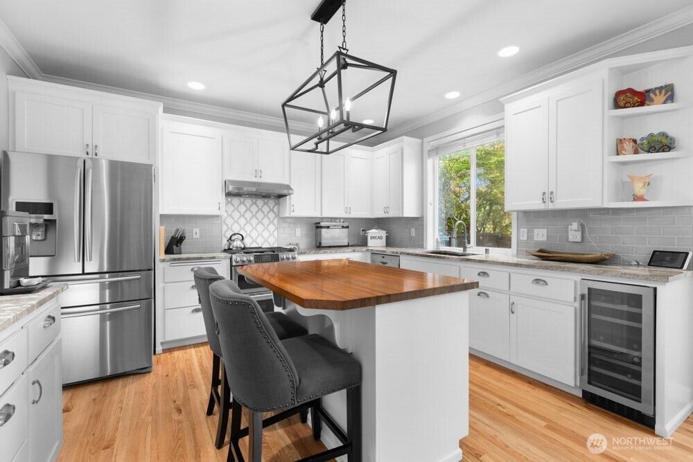 Modern granite countertops pair beautifully with freshly painted cabinetry for a bright, updated look.