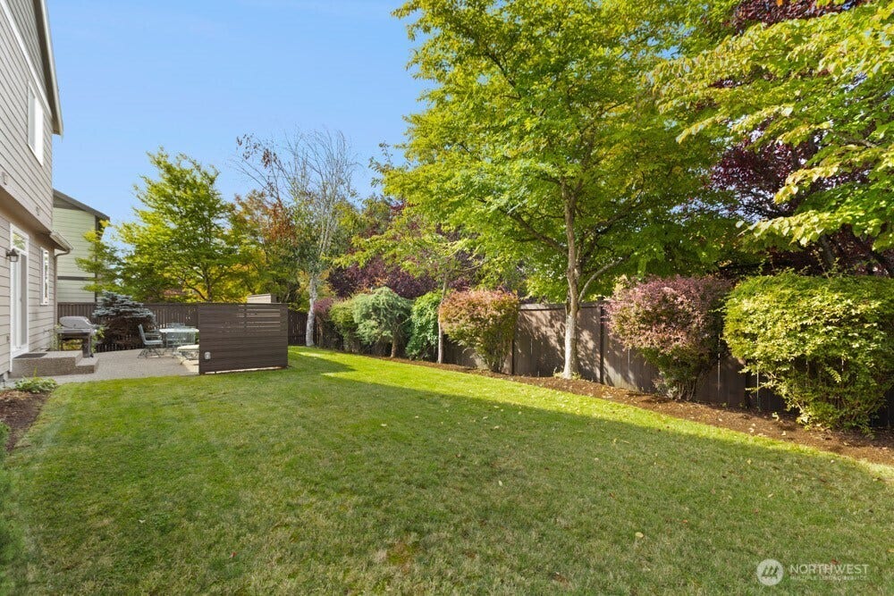 Mature landscaping surrounds the outdoor space, creating a beautiful, established setting.