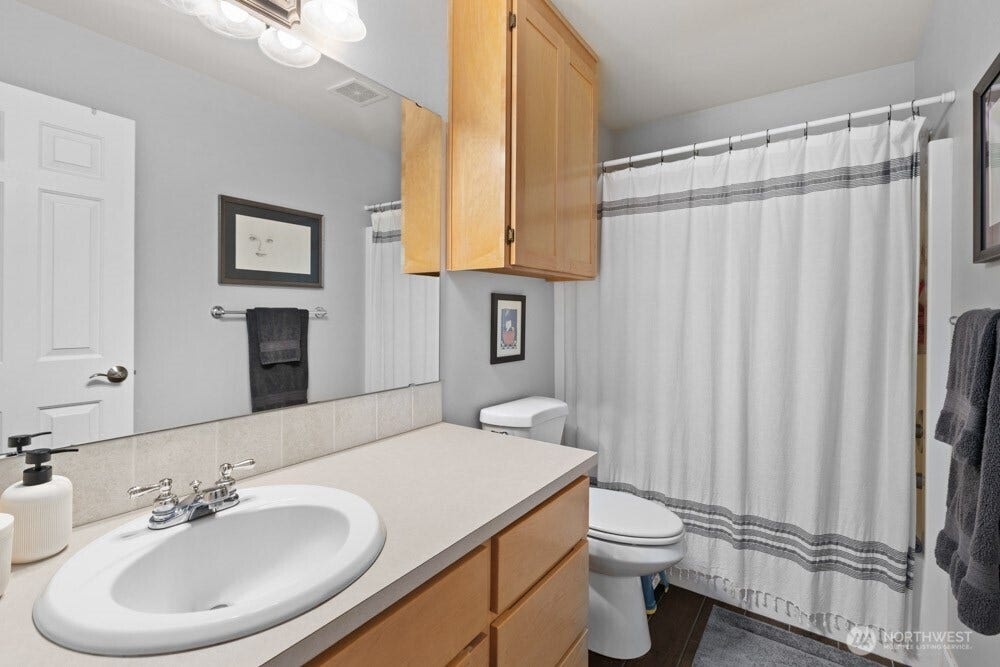 The full bath is conveniently located between the bedrooms for easy access.