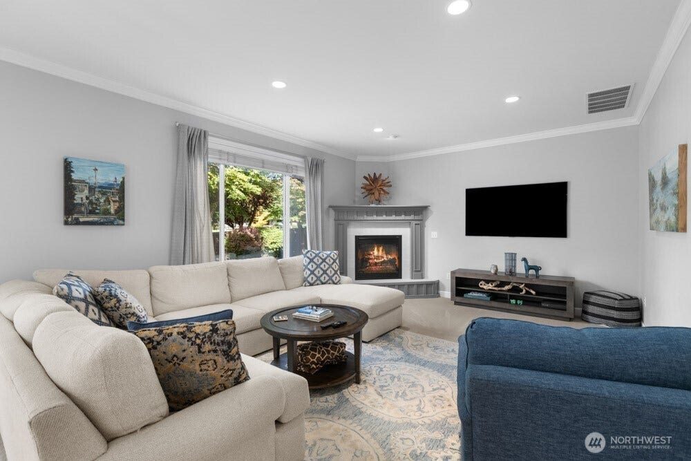 Cozy up by the gas fireplace while the oversized window frames the beautiful fall foliage outside.