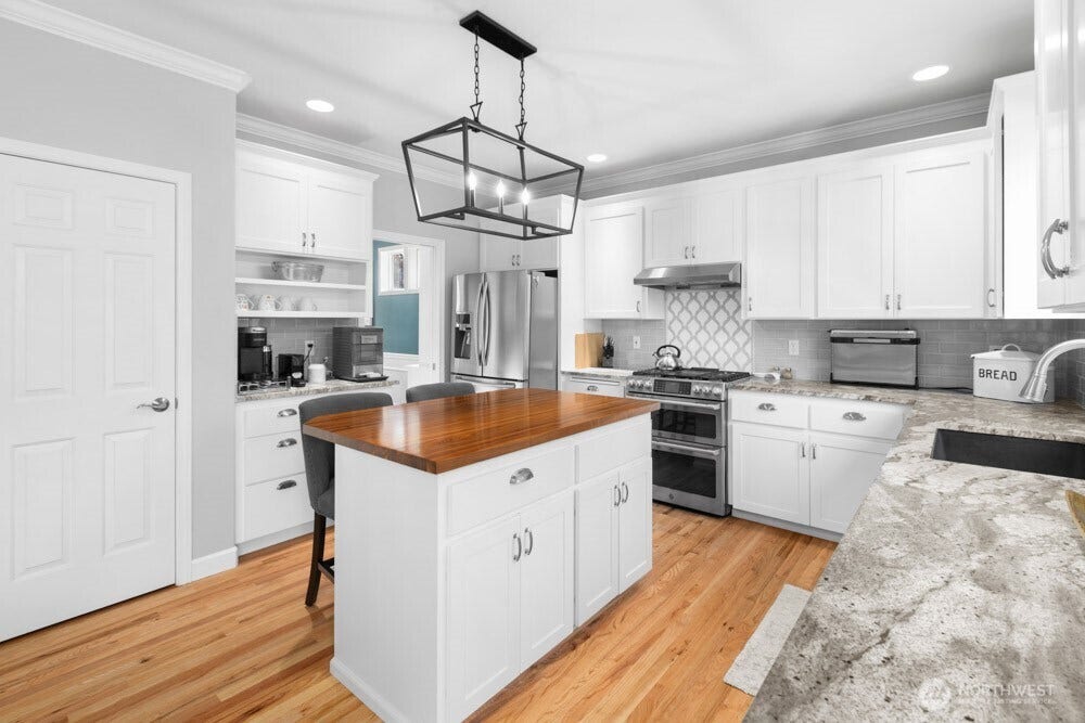 A walk-in pantry and abundant cabinetry provide plenty of storage space.