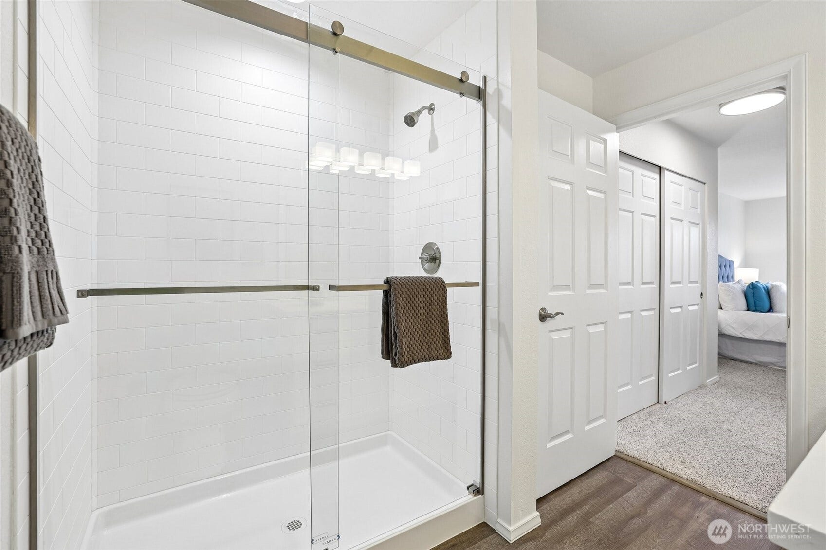 NEW Glass enclosed step in shower with floor to ceiling tiling