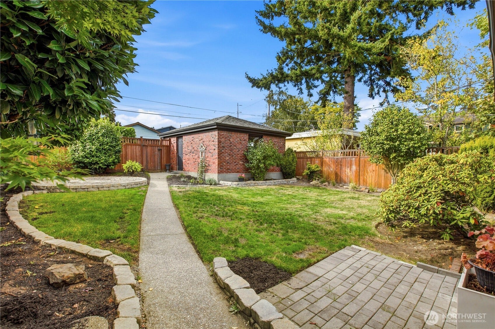 1910 N Union Avenue, Tacoma, WA 98406 Mature landscaped lot, fully fenced, with firepit area and an oversized one car brick garage matching the home!