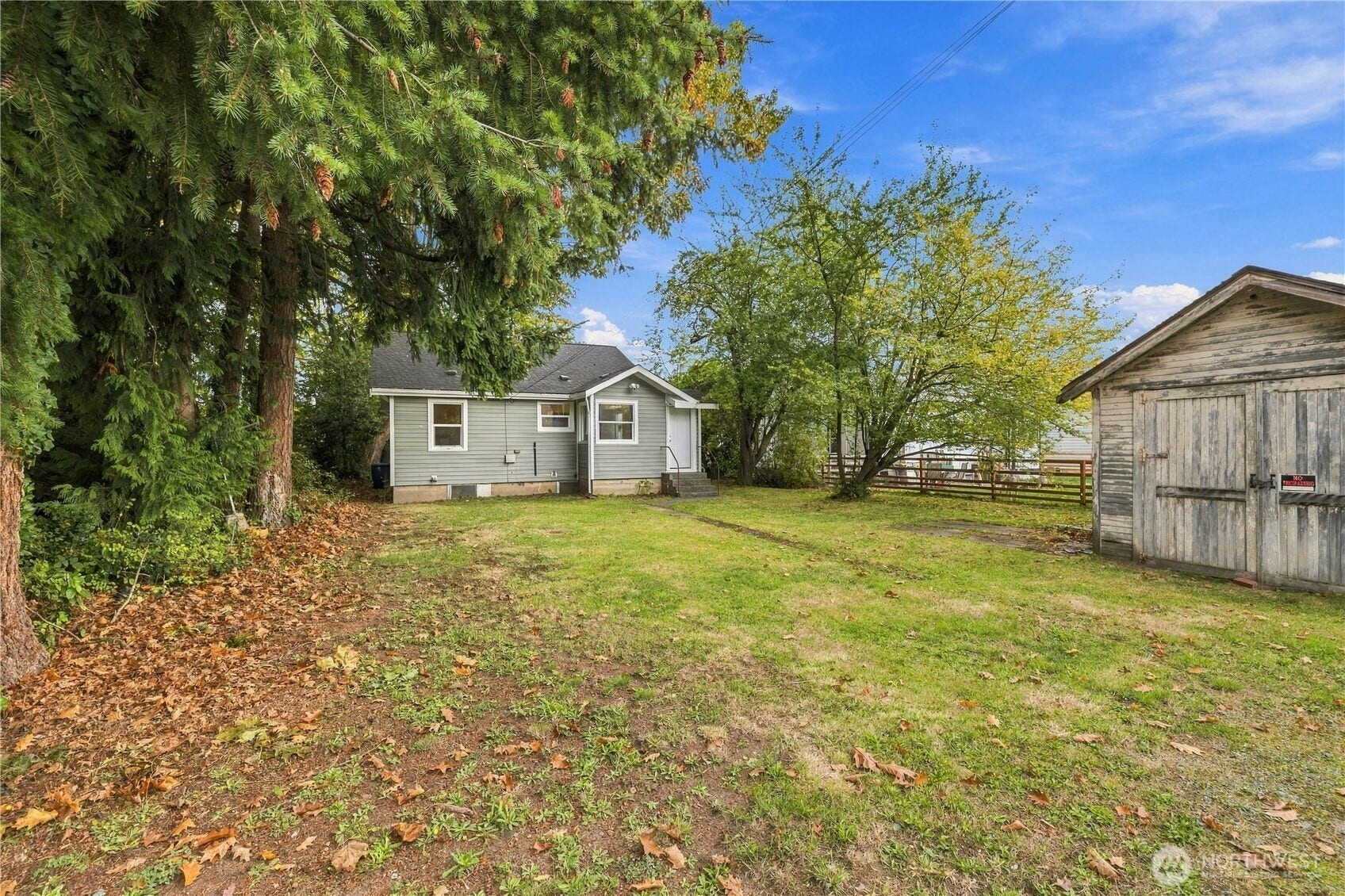 513 Warner Street, Sedro Woolley, WA 98284 Photo of the back of the home with a yard and a backyard garage
