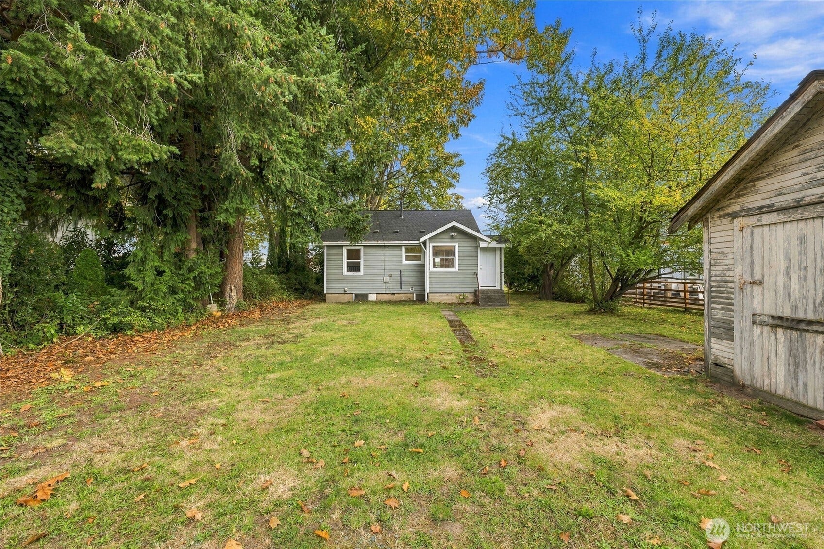513 Warner Street, Sedro Woolley, WA 98284 Photo of the back of the home with a yard and a backyard garage