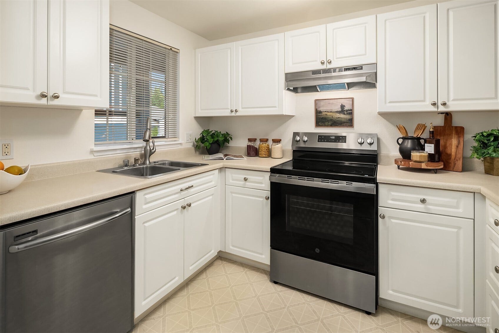 Light and bright kitchen! Stainless appliances + new plantation blinds in the window!