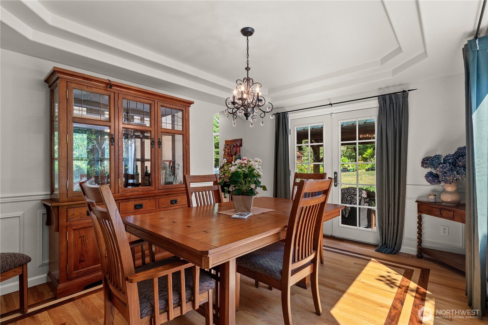 23924 SE 186th Street, Maple Valley, WA 98038 French doors to outdoor covered patio and BBQ area. This formal space has excellent natural light from the eastern sunny side of the home. Coffered ceilings and inlaid walnut on the oak flooring.