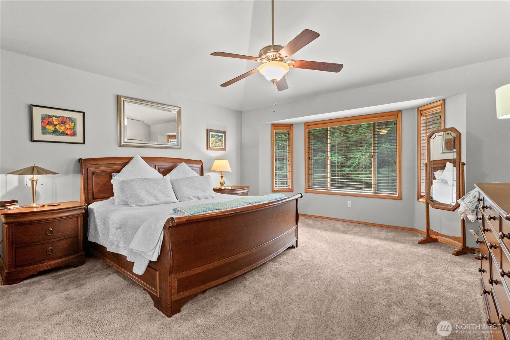 23924 SE 186th Street, Maple Valley, WA 98038 Primary suite with vaulted ceilings and large windows. King sized bed with side tables.