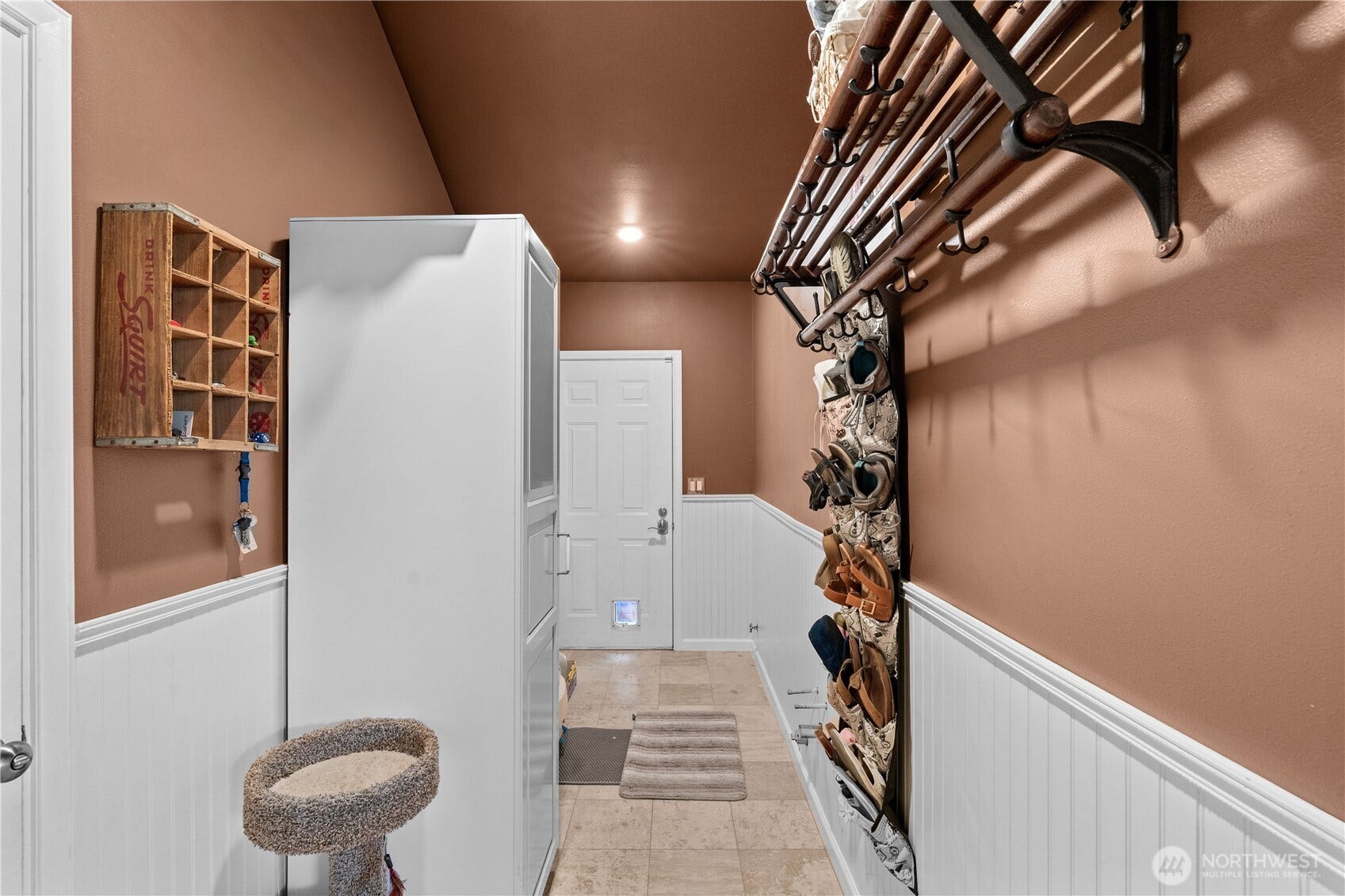 23924 SE 186th Street, Maple Valley, WA 98038 A mudroom with doors to the garage as well as the side patio.