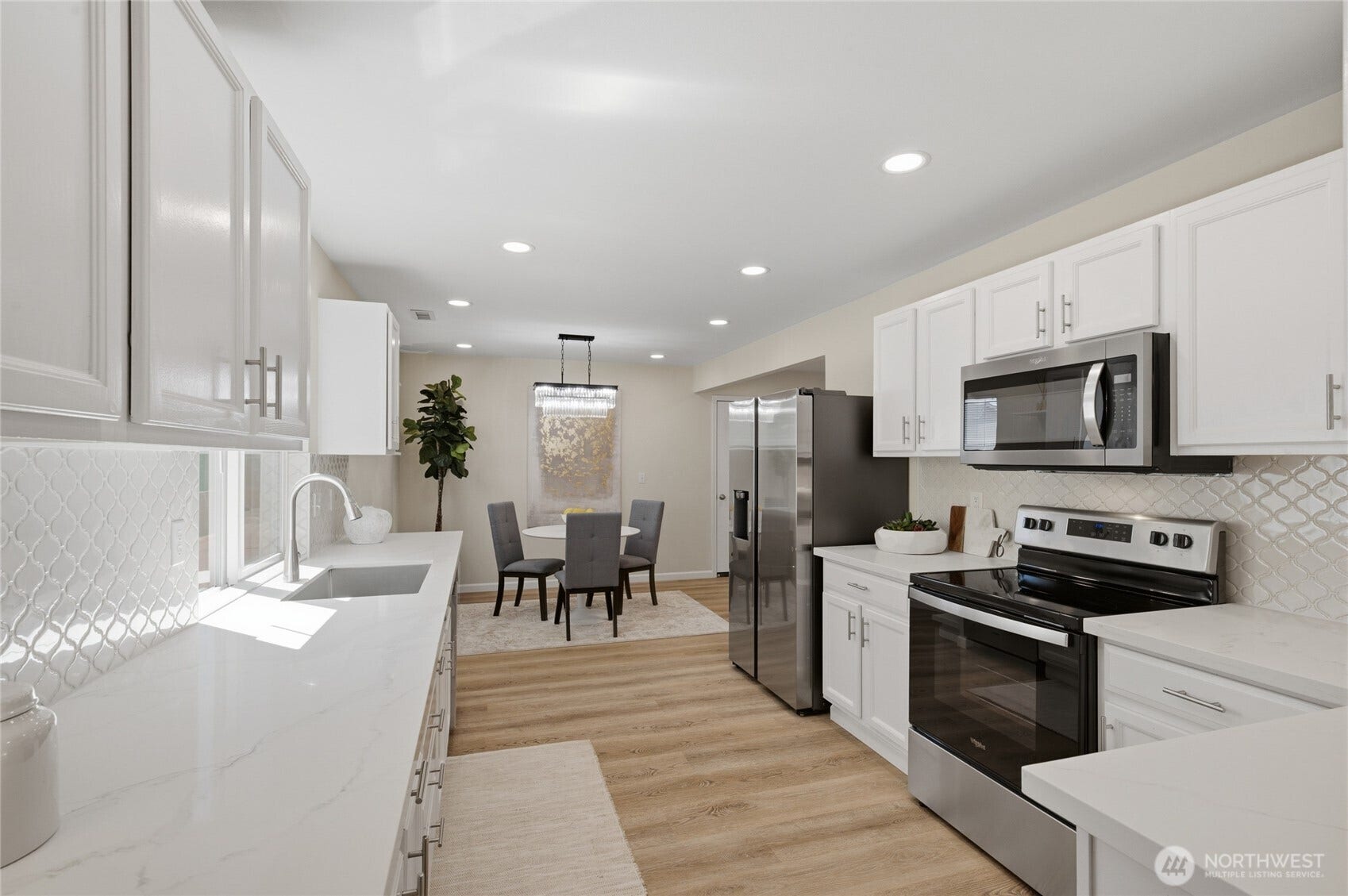 Quartz countertops steal the show. Designer backsplash, endless inspiration. Stainless steel appliances complete the space.