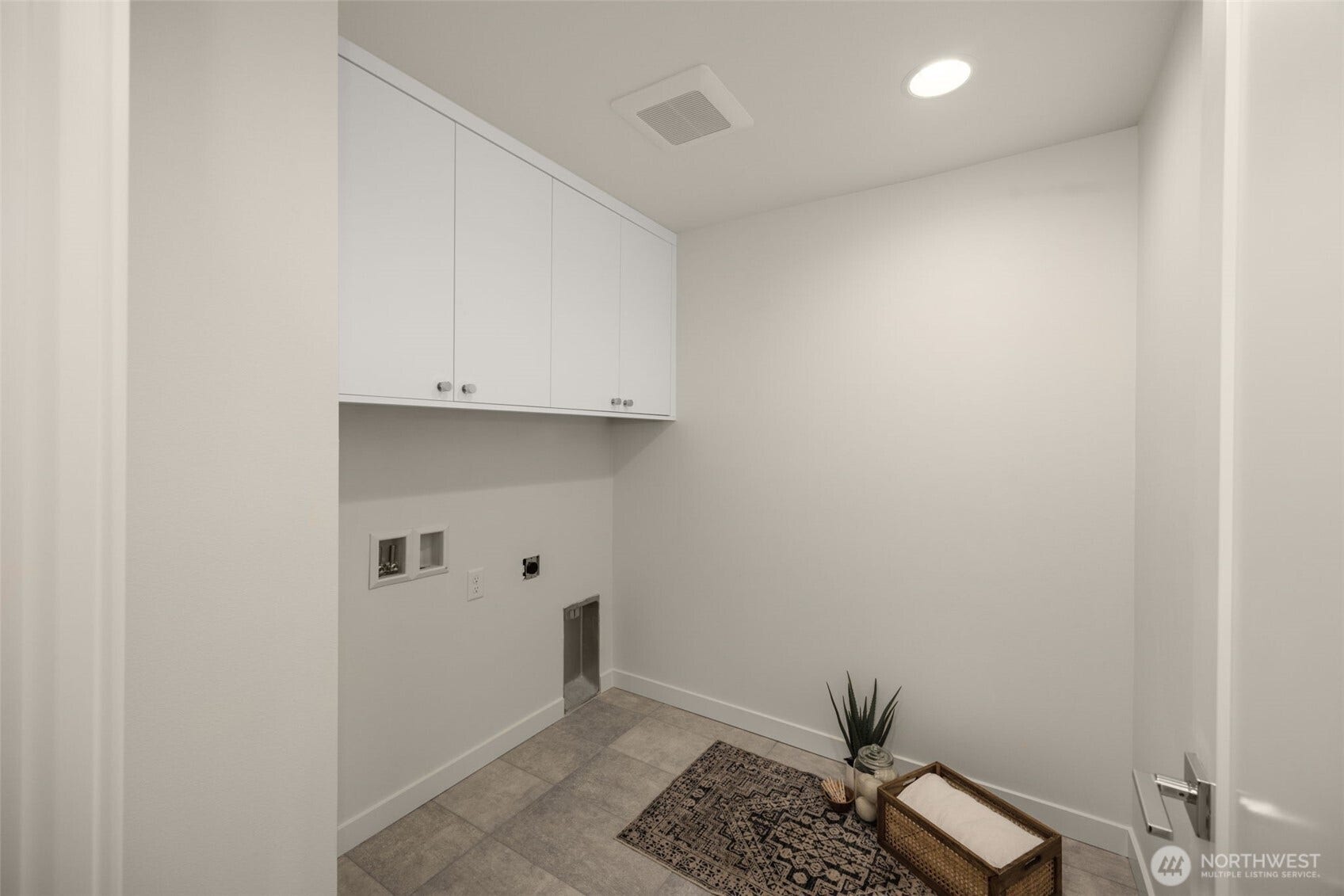 Laundry area with upper cabinets