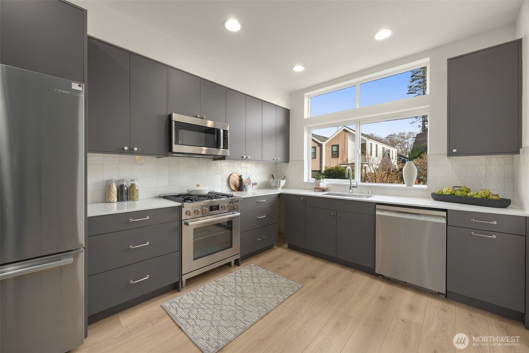 Window over the sink and full-height cabinetry