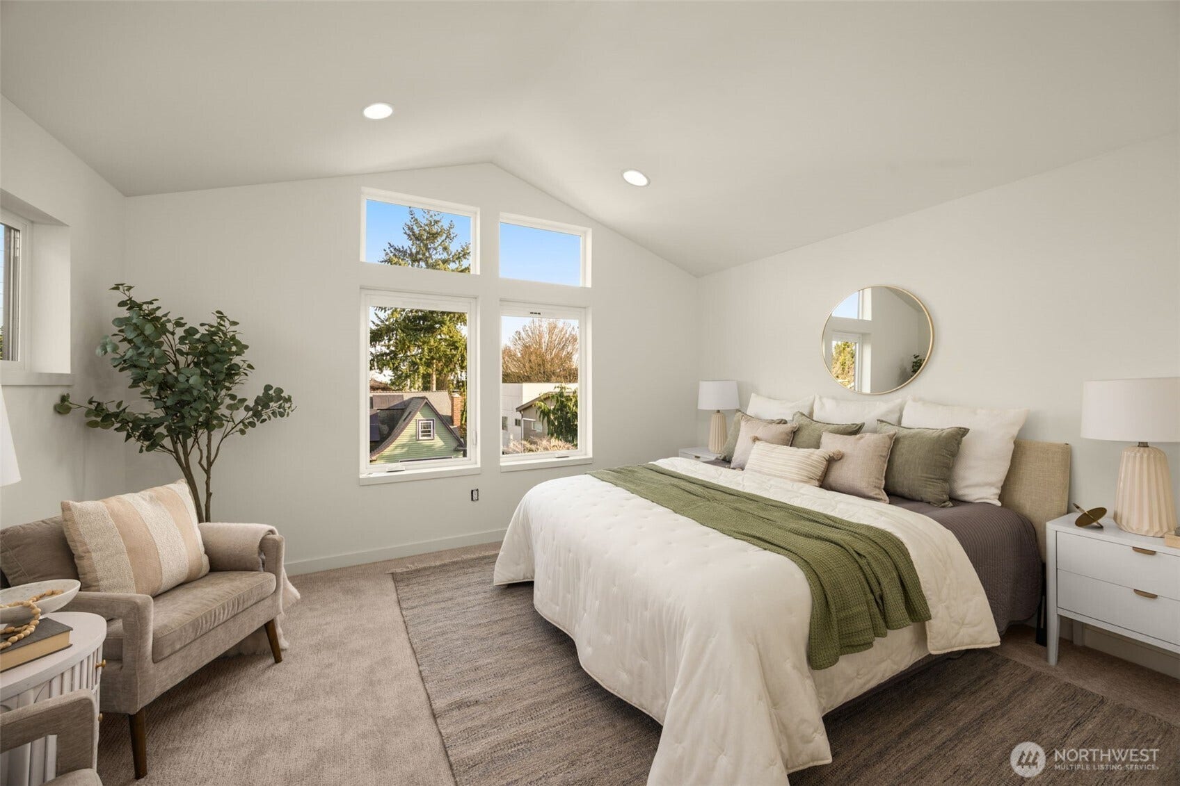 Primary bedroom with vaulted ceilings and abundant light
