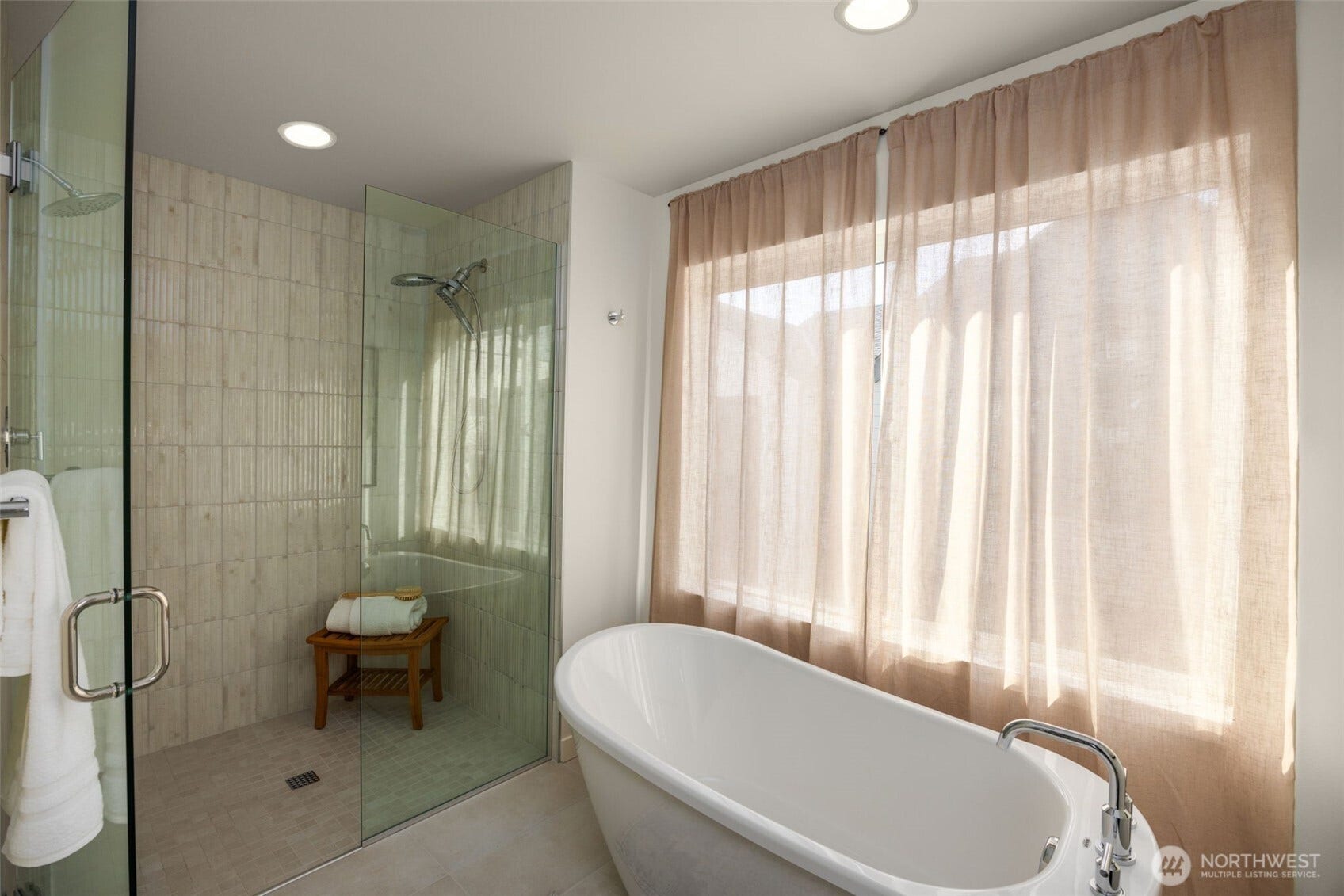 Soaking tub next to a glass-enclosed shower