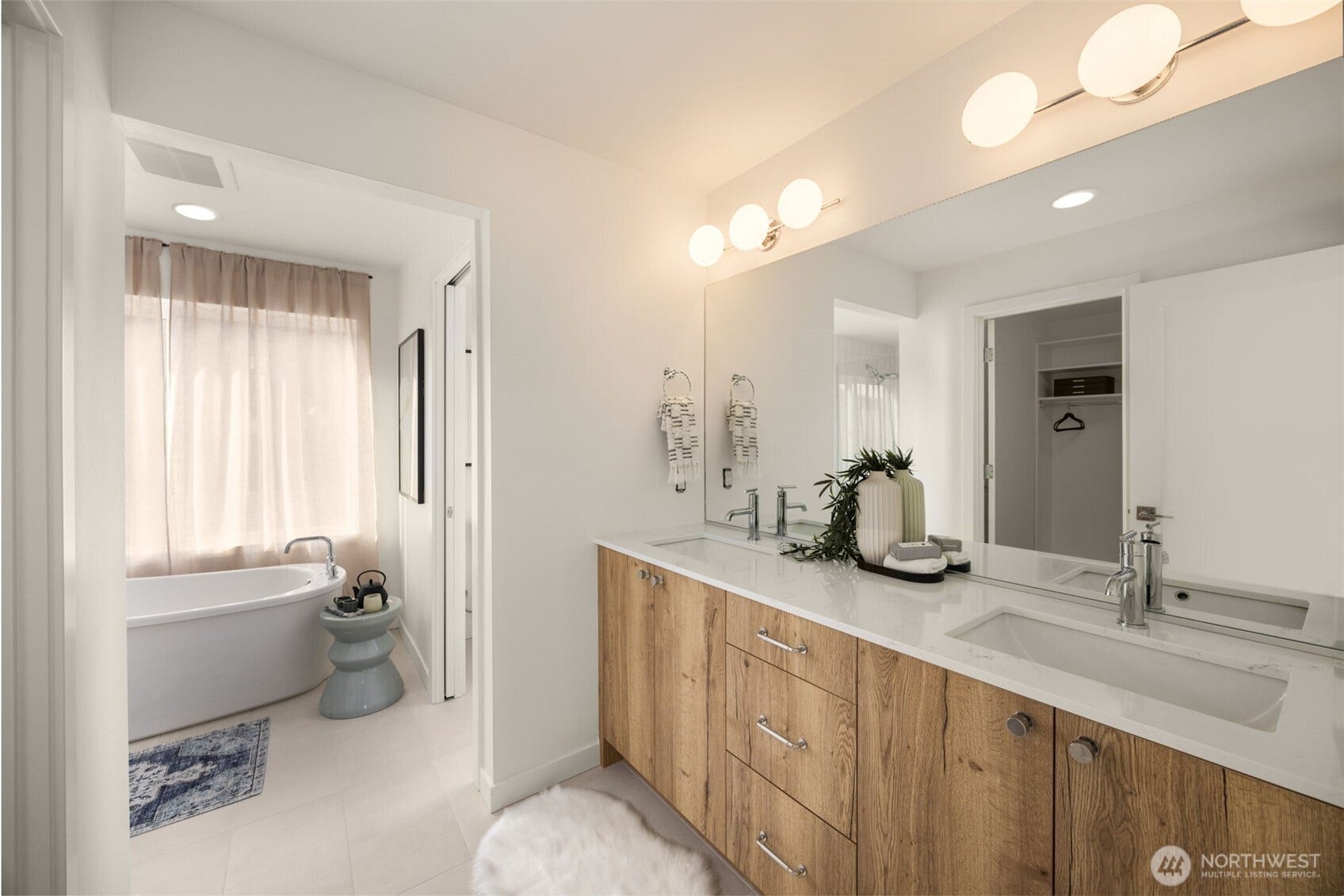 Double vanity with warm wood cabinetry