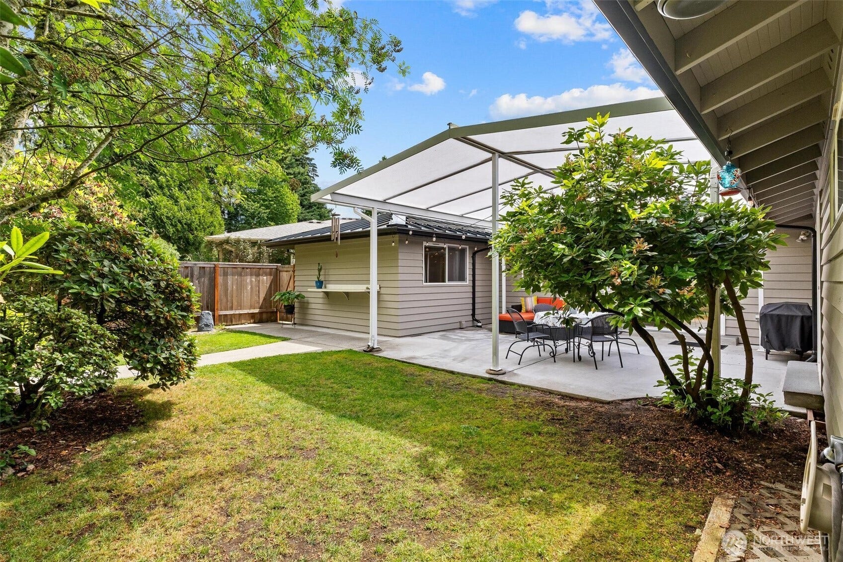 Rear yar with paved walkway to outbuildings.