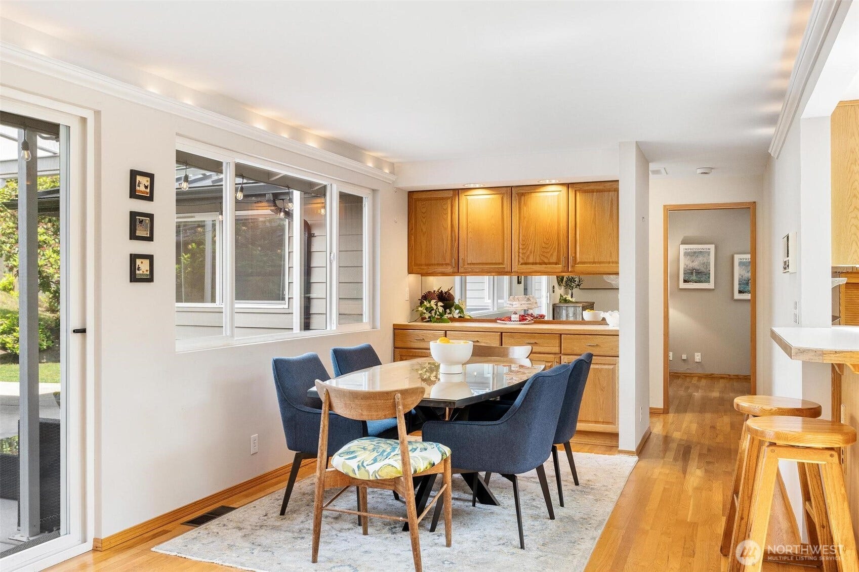 Custom built in cabinetry in the dining room. Accent lighting. Eat-in bar seating.