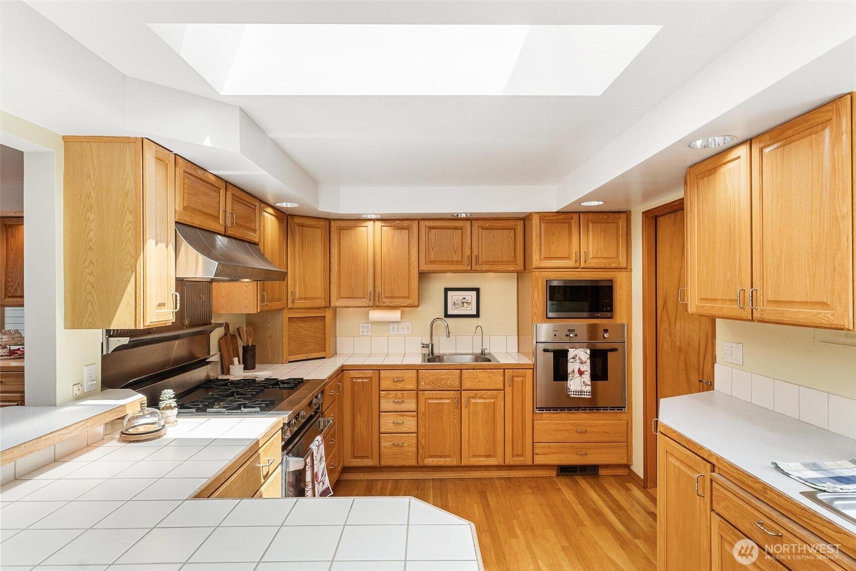 Entertaining is made easier with two ovens, a large gas range, microwave, two sinks, and plenty of prep space.