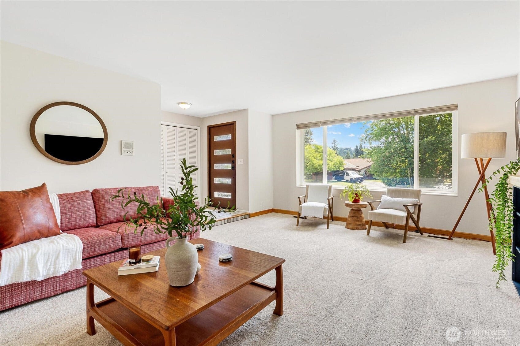 Living room with a large picture window bringing in lots of natural light.