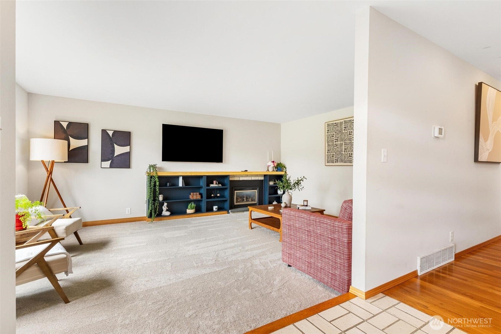 Living room with gas fireplace and custom mantle and surround. Underneath the new carpet and pad are beautiful Parque floors