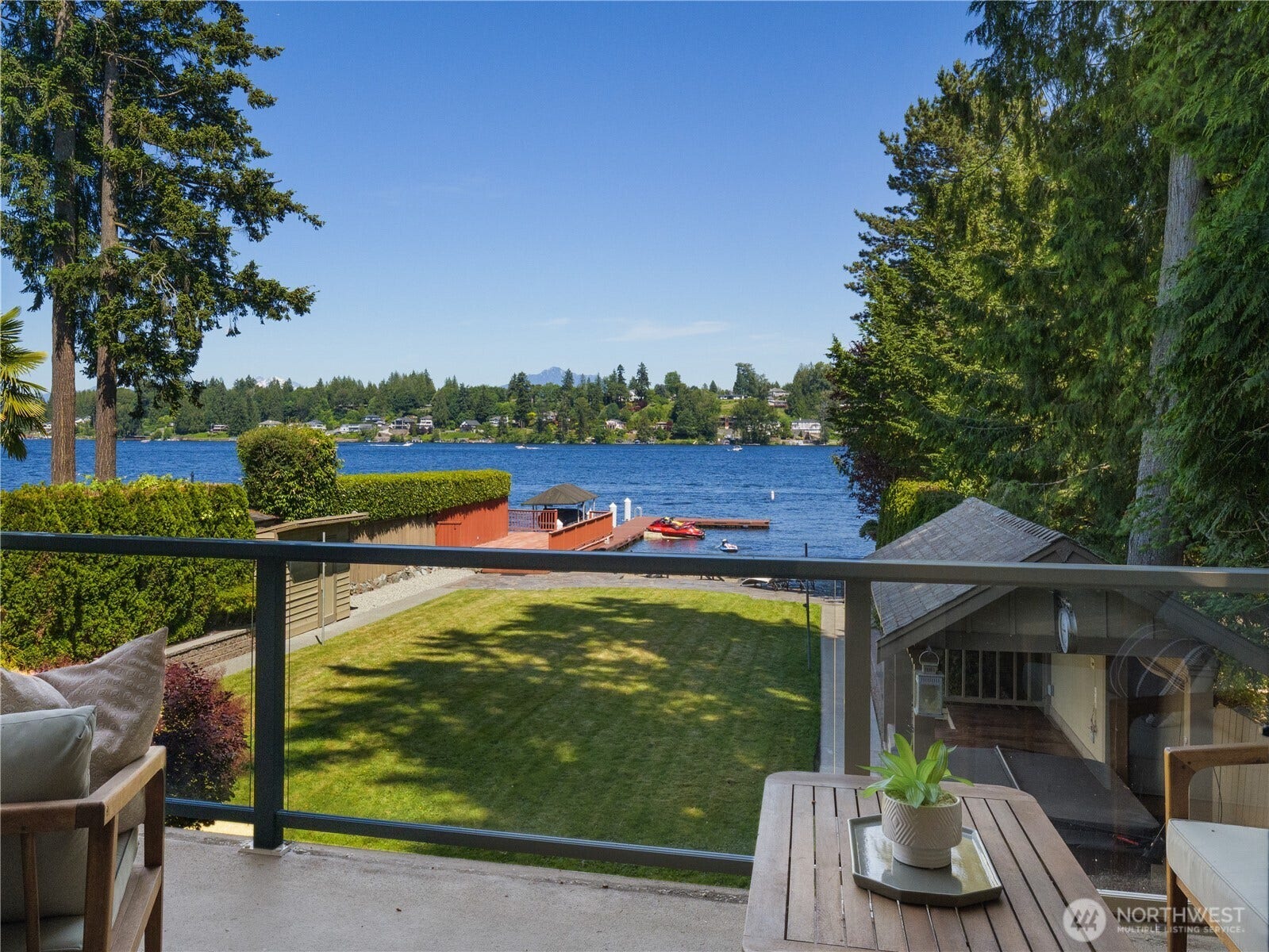 The primary suite's private balcony offers a peaceful outdoor escape with expansive views of the lake, shoreline, and beautifully maintained grounds below. Whether enjoying a morning beverage or unwinding at the end of the day, this inviting space provides a scenic vantage point and seamless access to the outdoors.