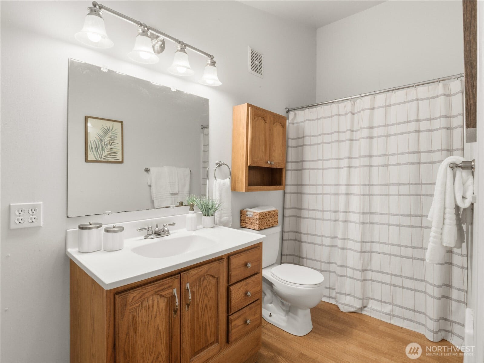 Conveniently located adjacent to the living area, this full bath offers a spacious vanity, abundant storage, and a tub/shower combination designed for practicality and comfort.