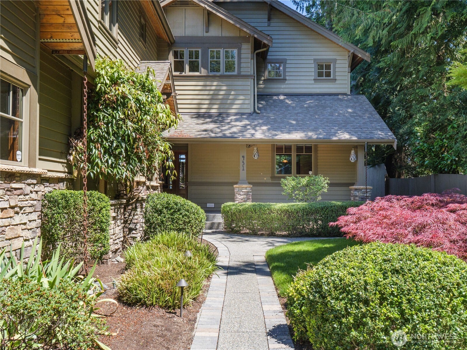 Arrive to stunning curb appeal featuring professionally maintained landscaping, a charming covered front porch, and classic Craftsman-inspired architecture.