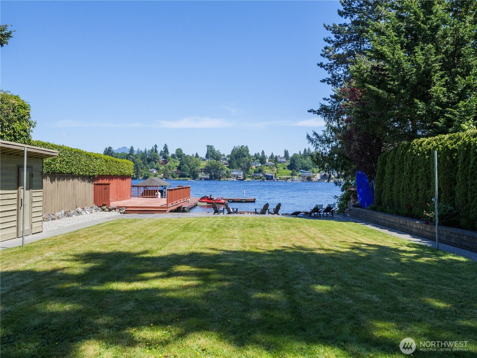 Level lawn stretches to the shoreline, creating a rare waterfront setting designed for recreation, relaxation, and entertaining.