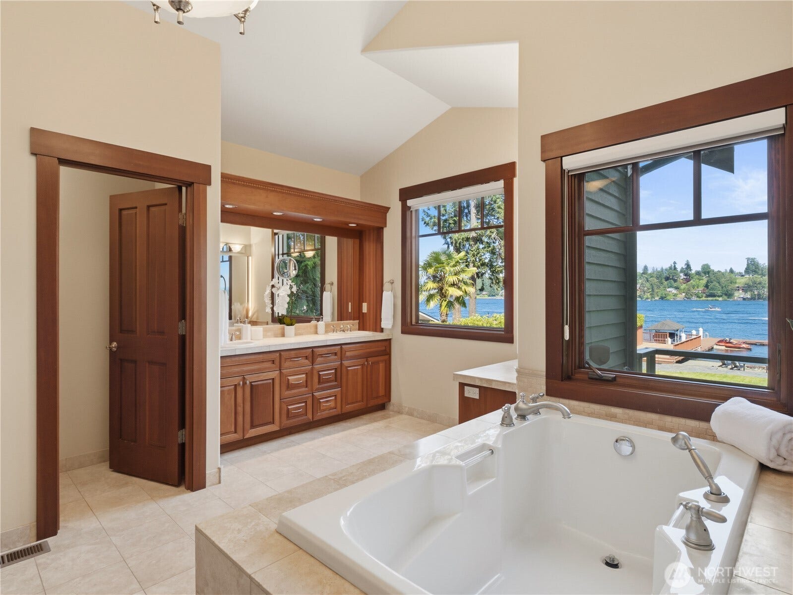 Large windows bring in natural light and showcase the surrounding landscape, while vaulted ceilings contribute to the spacious feel.