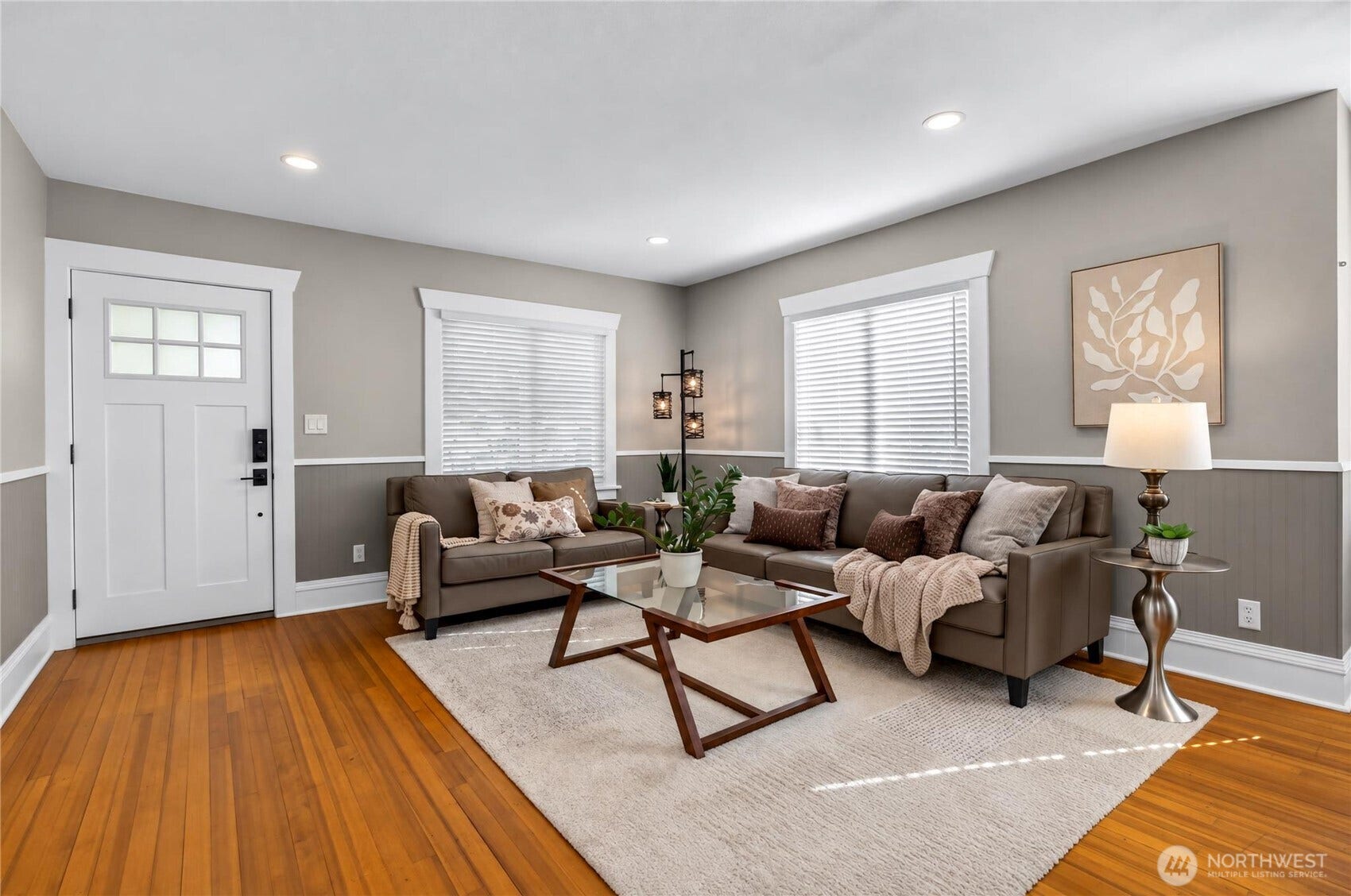 Light-filled living room with original hardwood floors in this North Everett Craftsman.