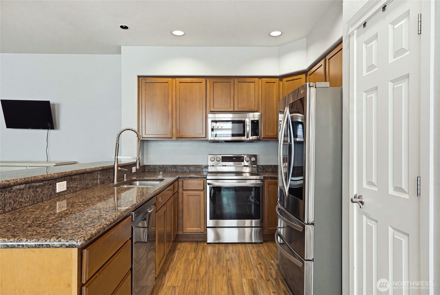 4628 Durham Street SE, Lacey, WA 98503 Kitchen with granite counters, maple cabinetry, and newer stainless appliances.
