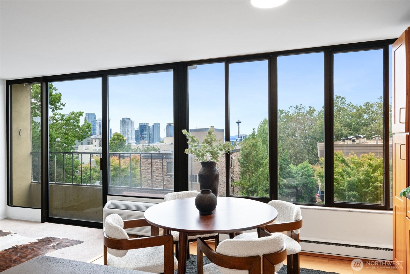 West-facing wall of windows with views of City, Bay, Mountains and Space Needle.