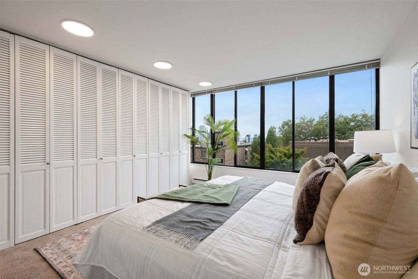 An open-concept kitchen featuring sleek granite slab countertops and upgraded appliances flows effortlessly into the dining area and spacious living room. The result is a beautifully connected space that blends comfort, style, and timeless elegance.
