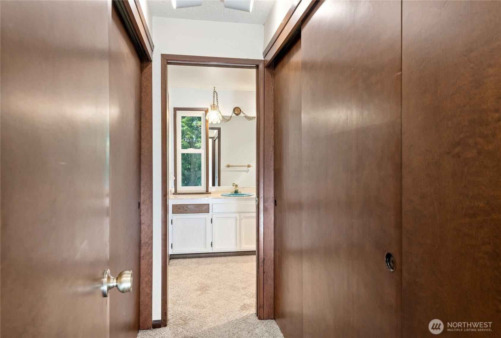 5628 139th Street NW, Gig Harbor, WA 98332 A hall of closets leads to the primary bath
