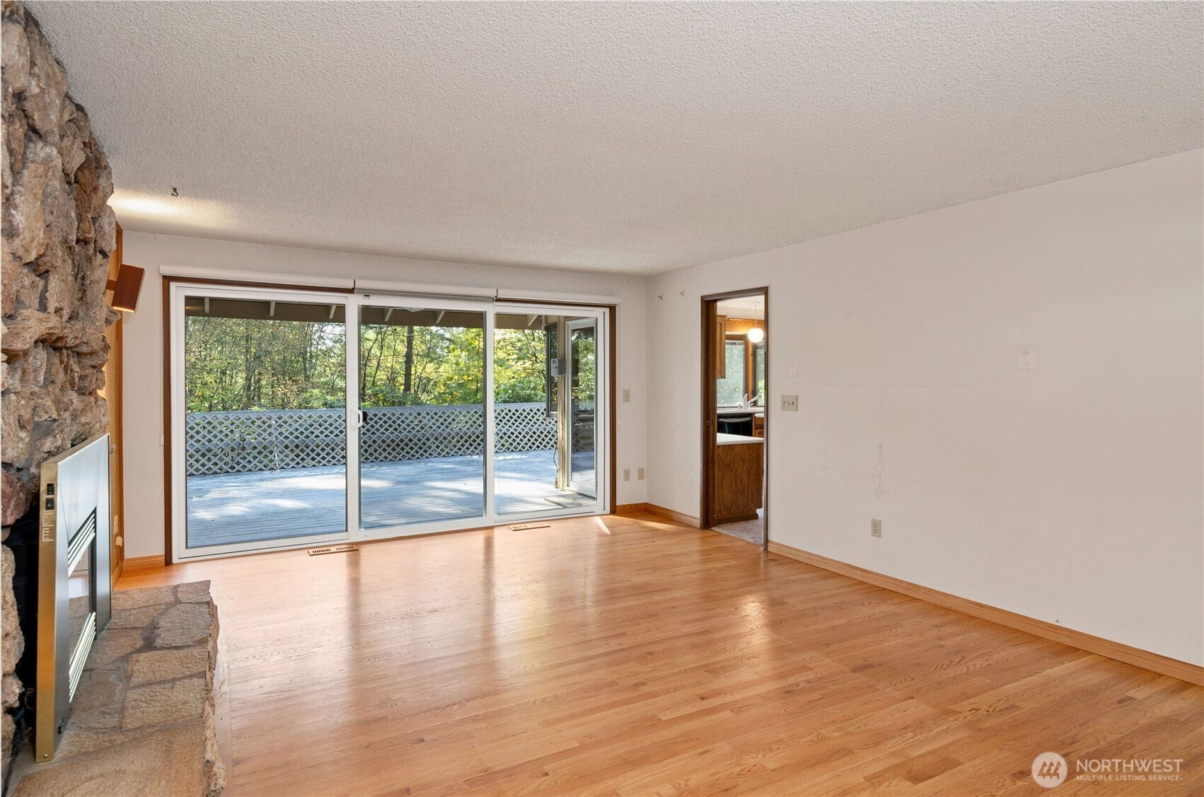 5628 139th Street NW, Gig Harbor, WA 98332 den with triple-slider to deck
