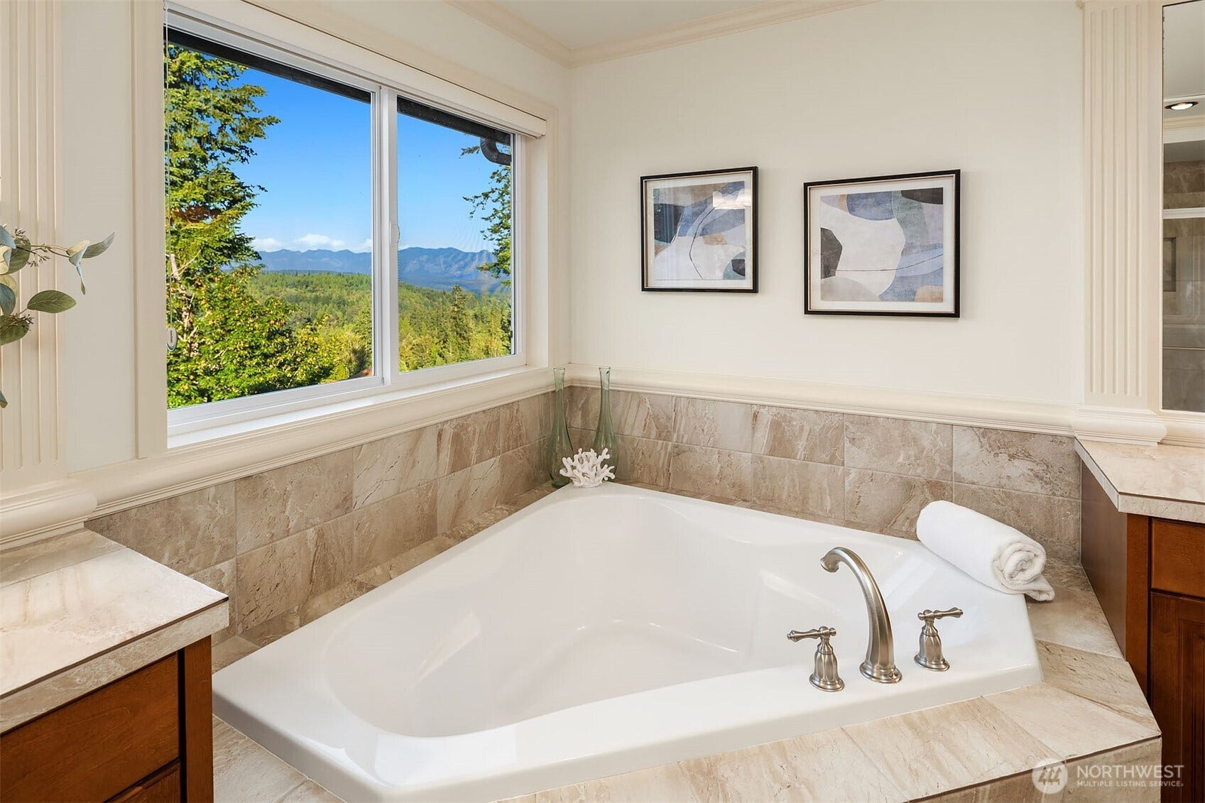 1836 273rd Place SE, Sammamish, WA 98075 Serene primary bath featuring a luxurious soaking tub, framed by picturesque mountain and scenic views, offering a private and peaceful retreat.