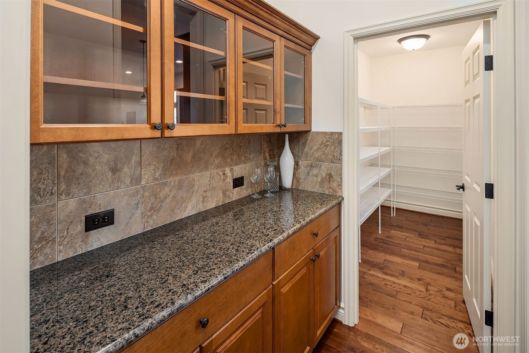 1836 273rd Place SE, Sammamish, WA 98075 The chef's kitchen features an expansive island, custom cabinetry, stainless steel appliances & an oversized walk-in pantry that feels like a room unto itself.