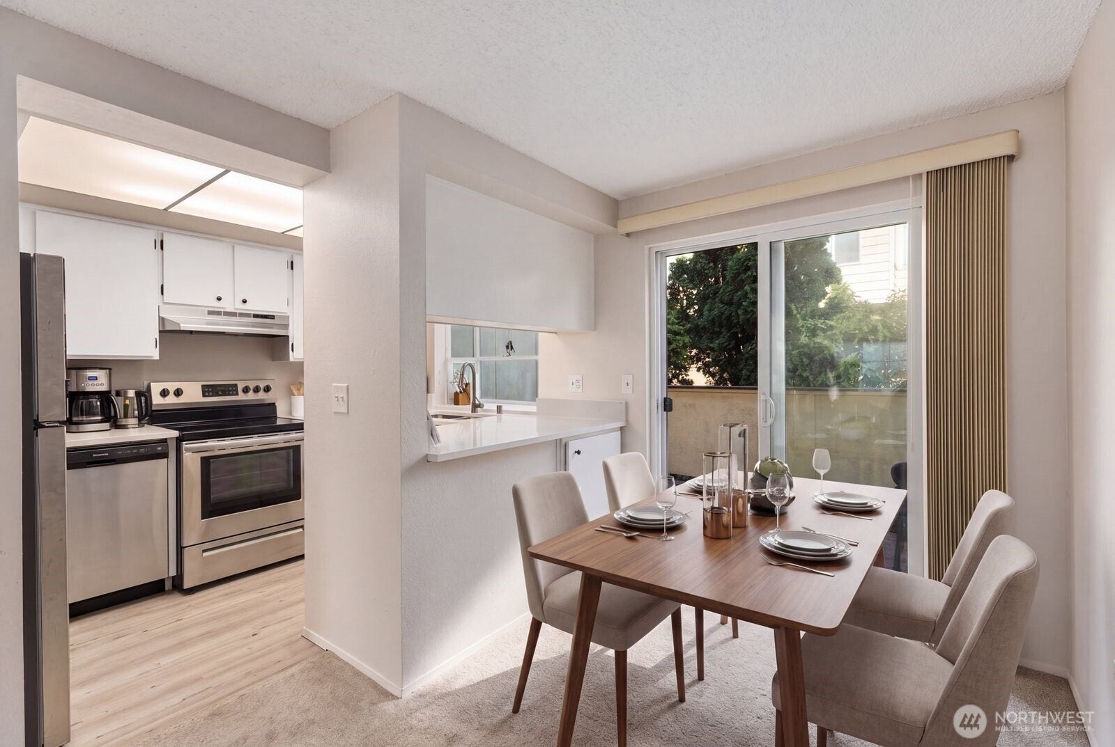 11802 98th Avenue NE, #B6, Kirkland, WA 98034 Great sized dining room that opens into the kitchen and living room. And flows onto your own private deck providing a truly great space. This picture was virtually staged.