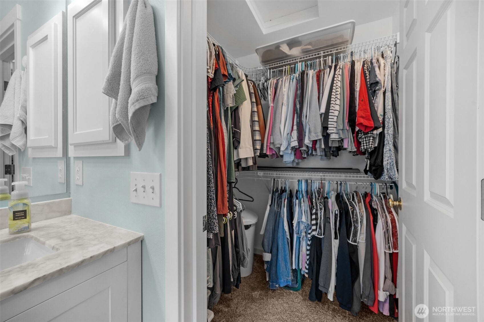 Partial view of the walk-in closet in primary bath.