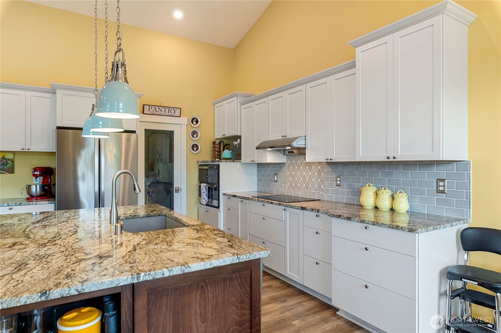 The kitchen is a gathering spot, lots of space to entertain and cook - all while seeing the views outdoors.