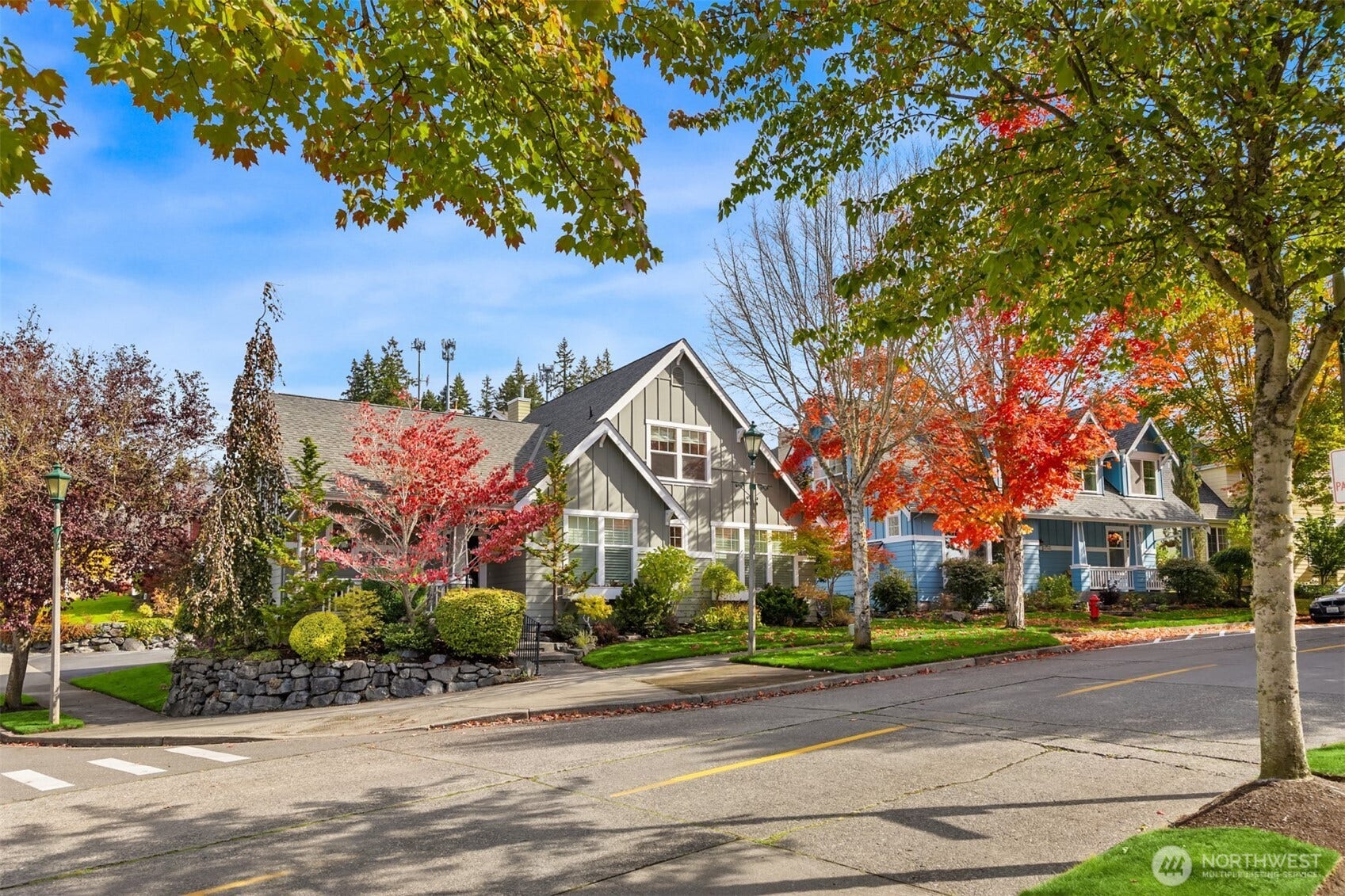 19800 Jensen Way NE, Poulsbo, WA 98370 Classic Northwest charm shines along this tree-lined streetscape, where vibrant fall foliage, manicured landscaping, and distinctive architecture create a welcoming first impression.